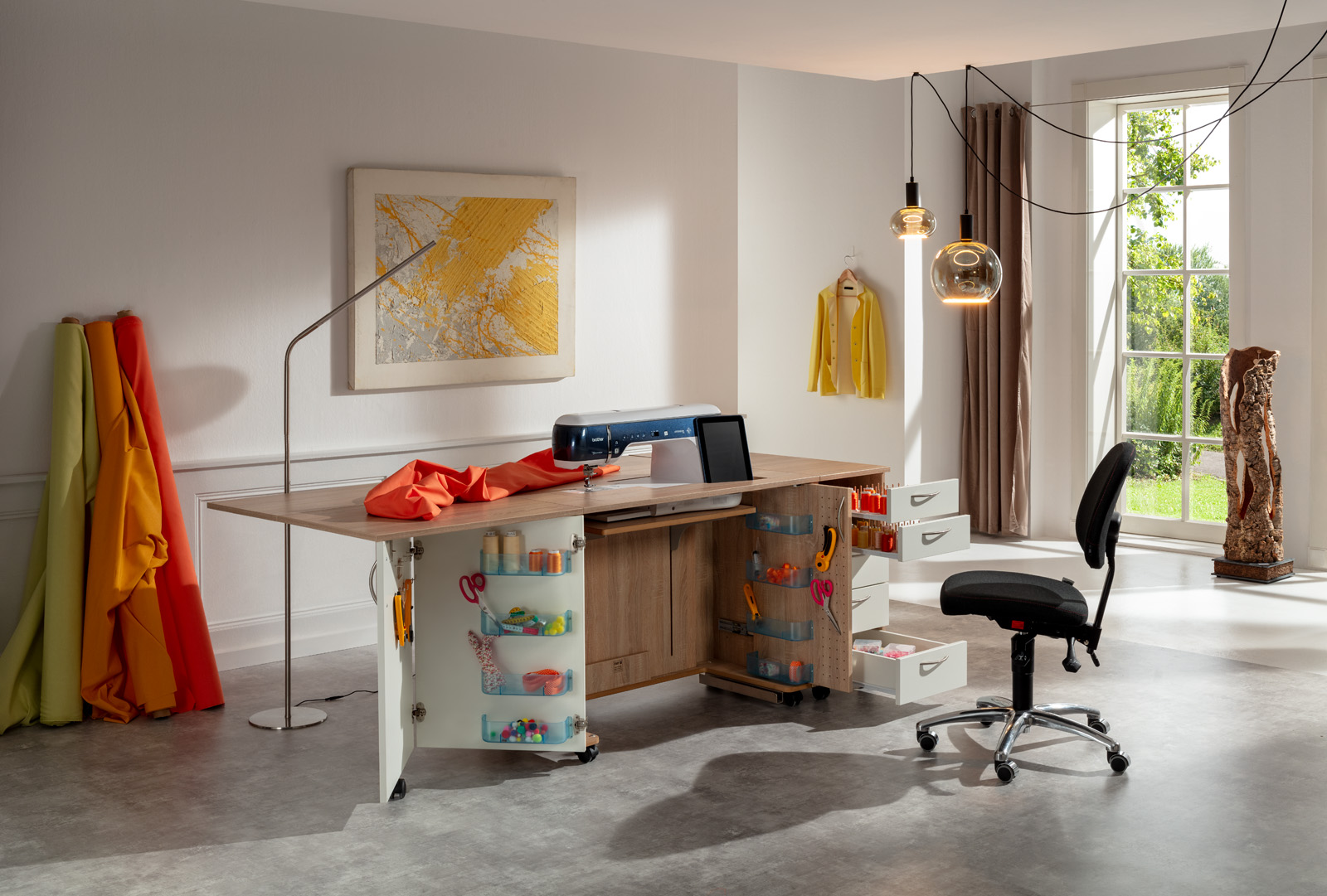 A well-lit room with complete set of sewing materials and furniture